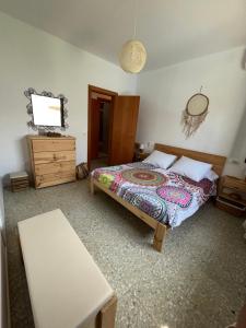 a bedroom with a bed and a wooden dresser at Casa Salada - Ideal famílies - Piscina ús exclusiu in Montroig +46 photos