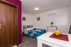 Cama o camas de una habitación en Apartments Tomaš
