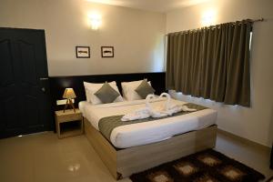 Postel nebo postele na pokoji v ubytování Veu Munnar Retreat - Valley View Rooms