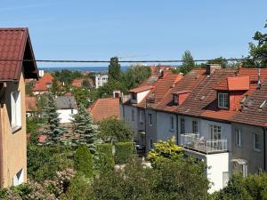 a group of houses with red roofs in a city at Apartament Słowackiego Sopot in Sopot