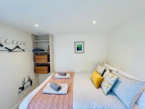 a bedroom with a bed with two pillows at Romantic Cabin Retreat on 50-Acre Suffolk Farm in Burgh
