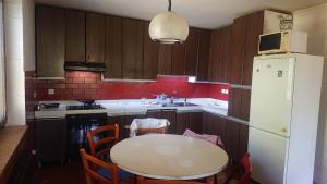 a kitchen with a table and a white refrigerator at Bernard bnb in Veliko Mlačevo