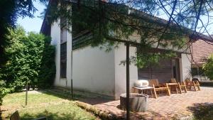 a patio with chairs and a table in front of a house at Bernard bnb in Veliko Mlačevo