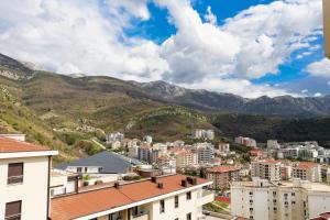 a view of a city with mountains in the background at Valeri Lux Becici in Rafailovici