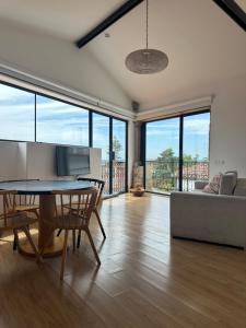 a living room with a table and chairs and a couch at Casa da Sé by PURUS in Coimbra