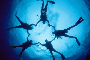 a group of people holding hands in the water at Garten House in Kornić