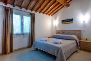 Ένα ή περισσότερα κρεβάτια σε δωμάτιο στο Camping Village Il Gineprino