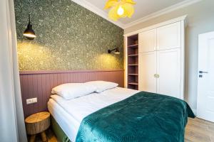 Postel nebo postele na pokoji v ubytování Apartamenty Galeria Trunków