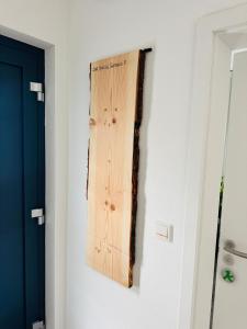 a piece of wood hanging on a wall next to a door at FeWo S26 in Krumbach +14 photos