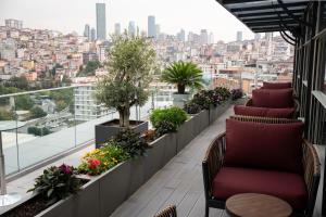 a balcony with chairs and a view of the city at Four Points by Sheraton Istanbul Kagithane in Istanbul