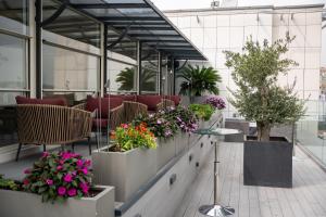 a lobby with flowers and plants inpots at Four Points by Sheraton Istanbul Kagithane in Istanbul