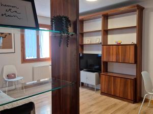 a living room with a glass table and a tv at Apartamento Uxín in Isaba