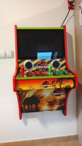 a video game machine is on display on a wall at Nuestro sueño jurásico in Barreiros
