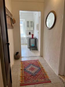 a hallway with a rug on the floor and a mirror at Panorama nel borgo in Monteciccardo