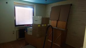 a room with boxes in a room with a window at Bernard bnb in Veliko Mlačevo