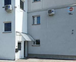 a white building with a door and a window at Apartament I Na Słonku in Dzierzgoń