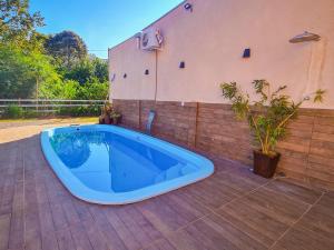 a large blue tub sitting on a patio at POUSADA MANACÁ DA SERRA in Vargem Bonita