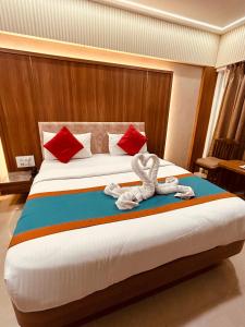 a hotel room with a bed with towels on it at Hotel Sahar International in Mumbai +10 photos
