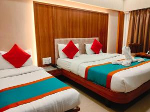 a bedroom with two beds with stuffed animals on them at Hotel Sahar International in Mumbai