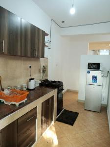 a kitchen with a stove and a refrigerator at SK Homes in Kilifi