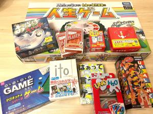 a pile of games and toys on a table at Naos House Hotel Osaka 5 in Osaka