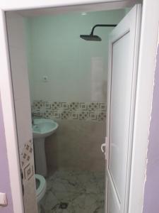 a bathroom with a toilet and a sink at Guesthouse Gurami in Borjomi +6 photos