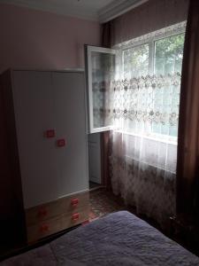 a bedroom with a dresser and a window at Guesthouse Gurami in Borjomi