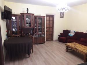 a living room with a couch and a table at Guesthouse Gurami in Borjomi