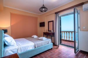 a bedroom with a bed and a view of the ocean at Villa sea view 1 in Athanion