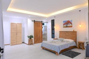 a bedroom with a bed and a sliding door at Lotus D`Or Villa in Trou aux Biches +42 photos