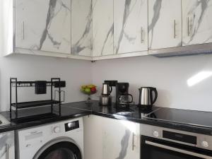 a kitchen with a washer and dryer on a counter at Mitropolis Apartment in Naxos Chora