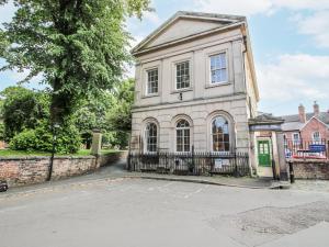an old house with a gate in front of a street at 1C College Hill in Shrewsbury