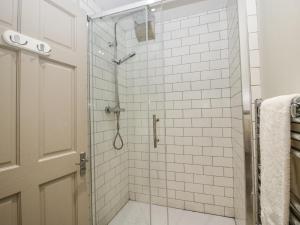 a bathroom with a shower with white tiles at 1C College Hill in Shrewsbury +18 photos