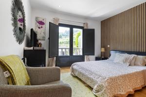 a bedroom with a bed and a chair and a window at Quinta Da Cevidade in Melgaço +46 photos