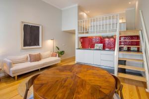 a living room with a table and a couch at Almada 151 - 2F in Porto +14 photos