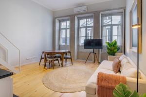 a living room with a couch and a table at Almada 151 - 2F in Porto