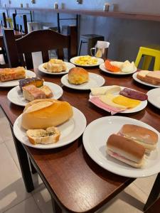 a wooden table with plates of food on it at Calandre Hotel in São Paulo