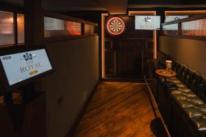 a room with a bar with a tv and a couch at The Royal Sutton in Sutton Coldfield