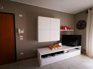a living room with a tv and a white cabinet at Your retreat in Mestre - Venezia comoda a due passi in Venice