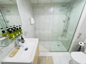 a bathroom with a shower and a sink and a toilet at DA86 - Well Design Studio in Dubai Arch tower in Dubai