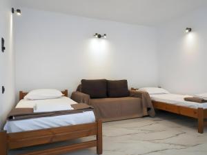 a living room with two beds and a couch at Mitropolis Apartment in Naxos Chora