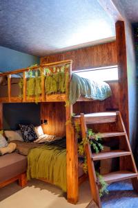 a bedroom with two bunk beds and a ladder at 100度越えサウナ,森林浴,絶景パノラマビュー,森の中の隠れ家,星見ジャグジー---ハーミットたいとう--- in Shiigi +40 photos