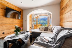 a living room with a couch and a table at Willa Turnia in Kościelisko