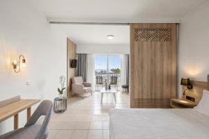 a bedroom with a bed and a living room at Kiotari Bay in Kiotari