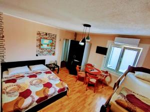 a bedroom with a bed and a table in it at Apartment Jonoski in Ohrid