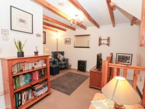 a living room with a book shelf with books at The Old Cottage in Staithes