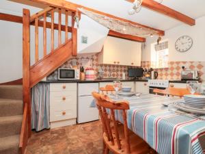 a kitchen and dining room with a table and chairs at The Old Cottage in Staithes