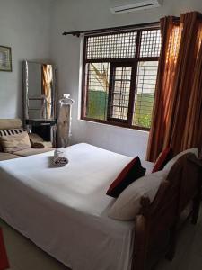 Postel nebo postele na pokoji v ubytování The Sanhida Guest House Colombo
