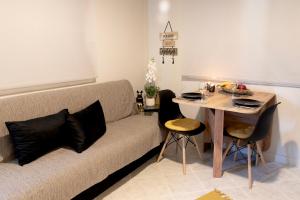 a living room with a couch and a table at Anndora in Chalkida