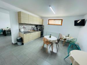 a kitchen and dining room with a table and chairs at Casa Sorriso in Turda
